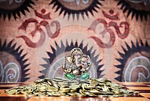 Ganesh on heap of coins photo