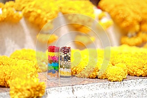 Ganesh offerings. Marigold flowers and 7 colors of rice and 7 ty