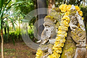 Ganesha coverd by moss in the park.Thailand