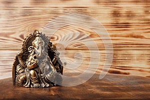 Ganesha god on wooden background