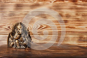 Ganesha god on wooden background