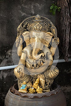 Ganesha sat on clay pots.