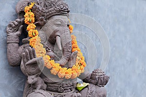 Ganesha sitting in meditating yoga pose in hindu temple