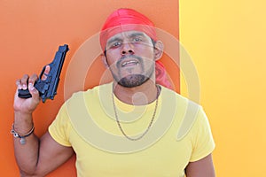 Gang member holding a gun