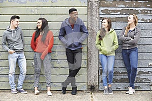 Gang Of Teenagers Hanging Out In Urban Environment photo