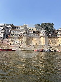 Ganges river with boats docked near the steps. Varanasi, Uttar Pradesh, India