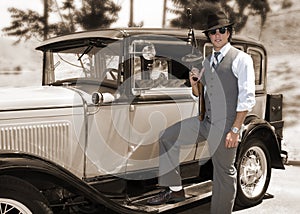Gangster with gun and old car