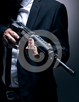 Gangster, hands or holding gun on studio background in dark secret spy,  mafia leadership or crime lord security