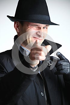Gangster man in hat pointing with hand