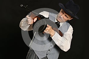 Gangster man in suit with gun