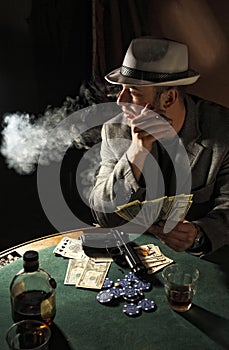 Gangster smoking and play poker