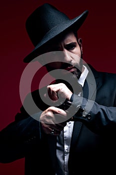 Gangster, suit or cocking gun on studio background in dark secret spy, isolated mafia leadership or crime safety. Model