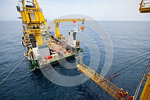 Gangway between barge and oil and gas platform, worker walked passed the way for work on the platform