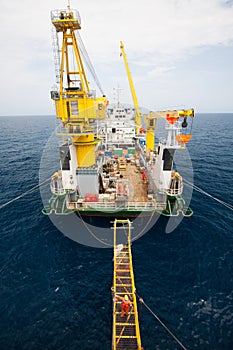 Gangway between barge and oil and gas platform, worker walked passed the way for work on the platform