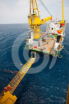 Gangway between barge and oil and gas platform, worker walked passed the way for work on the platform photo