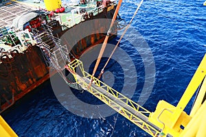 Gangway from supply boat or barge to the oil and gas platform. The activity supported man power to work on the platform.
