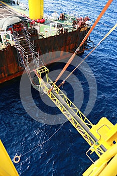 Gangway from supply boat or barge to the oil and gas platform. The activity supported man power to work on the platform.
