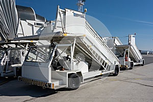 Gangways of airplan at the airport. Passenger`s boarding ramps. Passenger`s ladders. Traveling and waiting for flight at the