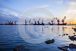 Gantry crane and cargo ship in the evening