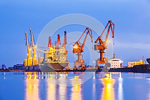 Gantry crane and cargo ship in the evening