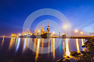 Gantry crane and cargo ship in the evening