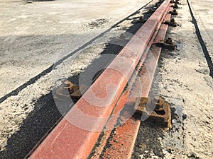 Gantry crane rail fastened to concrete foundation with anchor bolts