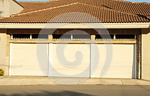 Garage building with closed white sectional gates