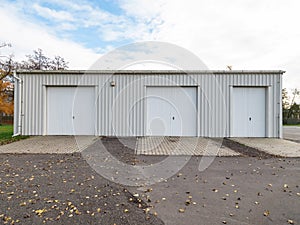 Garage building made of concrete with roller shutter doors. Modern building