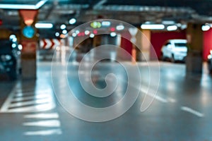 Garage car blurred. Car lot parking space in underground city garage. Empty road asphalt background in soft focus