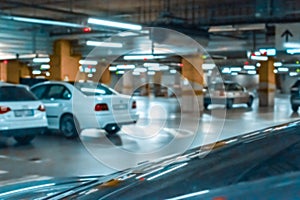 Garage car blurred. Car lot parking space in underground city garage. Empty road asphalt background in soft focus. Concrete