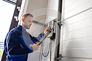 Garage Door Installation And Repair At Home. Contractor Man