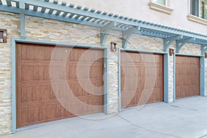 Garage exterior with wall-mounted light blue pergola and doorframe