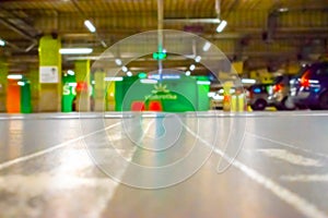 Garage interior blurred. Car lot parking space in underground city garage. Empty road asphalt background in soft focus