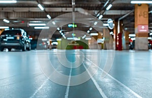 Garage interior blurred. Car lot parking space in underground city garage. Empty road asphalt background in soft focus. Large