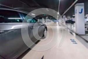 Garage interior blurred. Car lot parking space in underground city garage. Empty road asphalt background in soft focus. Large