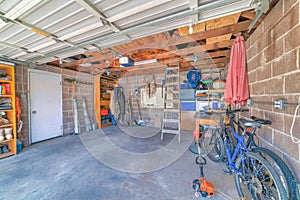 Garage interior with garden tools and two bicycles