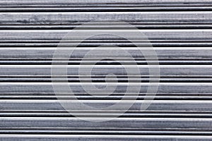 Garage metal door stripped texture. Rolling steel doors background.