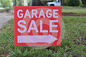 Garage Sale Sign in Grass with Arrow Pointing Right, Small Town USA