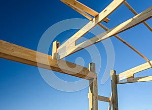 Garage truss pole building. Timber, wooden truss attachment. Construction site framing