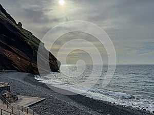 Garajau - Panoramic view of idyllic volcanic black stone beach of Praia Garajai, Canico, Madeira island, Portugal, Europe