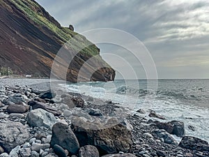 Garajau - Panoramic view of idyllic volcanic black stone beach of Praia Garajai, Canico, Madeira island, Portugal, Europe