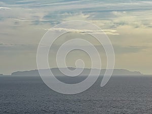 Garajau - Panoramic view of remote island Desert Grande seen from Cristo Rei in Garajau, Madeira island