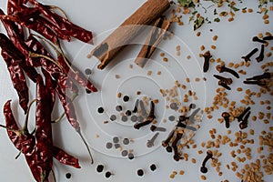 Garam masala powder in bowl and it`s ingredients colourful spices. Served over moody background. selective focus