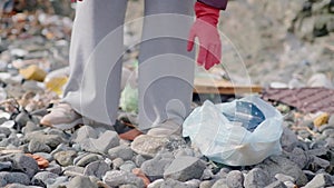 garbage bag full of plastic waste collected by woman from the beach. protecting from pollution