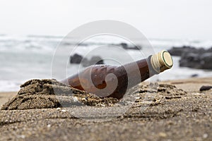 Garbage on a beach, glass bottle