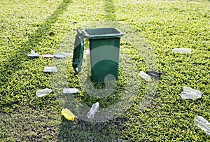 Garbage bin and garbage on the ground