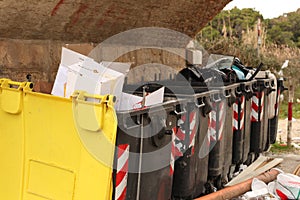 Garbage bins overflowing angled view