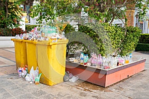 Garbage bins are overflowing since there are not enough receptacles and bins to handle the flow of waste for that area