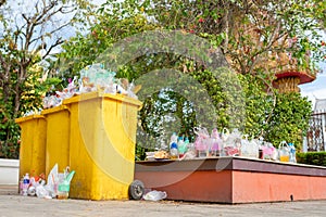 Garbage bins are overflowing since there are not enough receptacles and bins to handle the flow of waste for that area photo