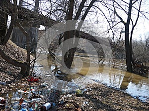 Garbage, bottles, mud in the spring. Environmental disaster.